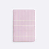 notebook with pink tile pattern sitting on white background
