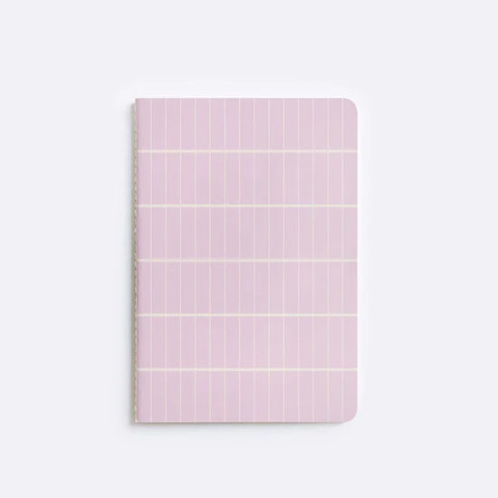 notebook with pink tile pattern sitting on white background