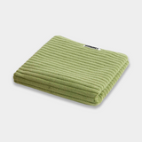light green bath mat sitting on white background