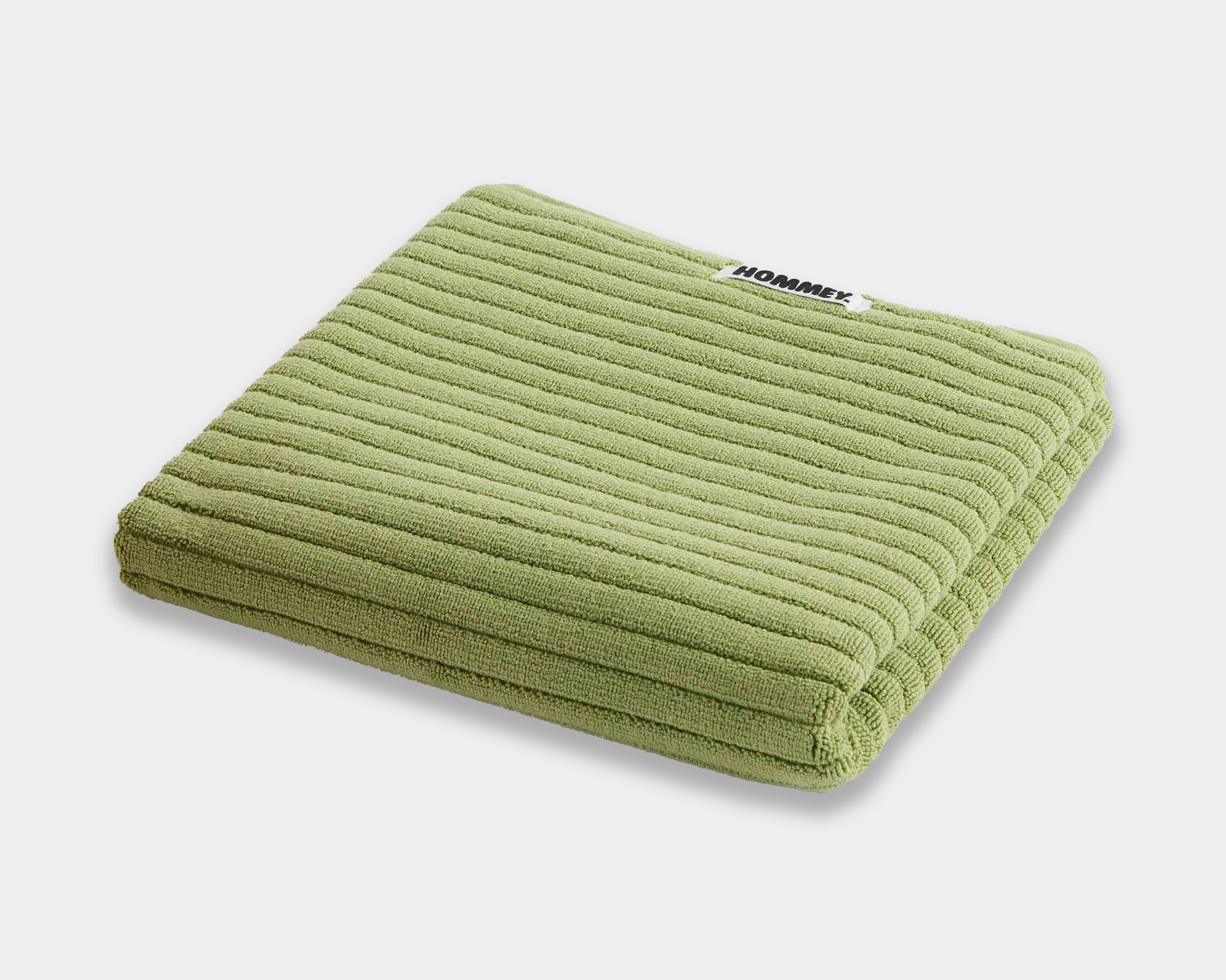 light green bath mat sitting on white background