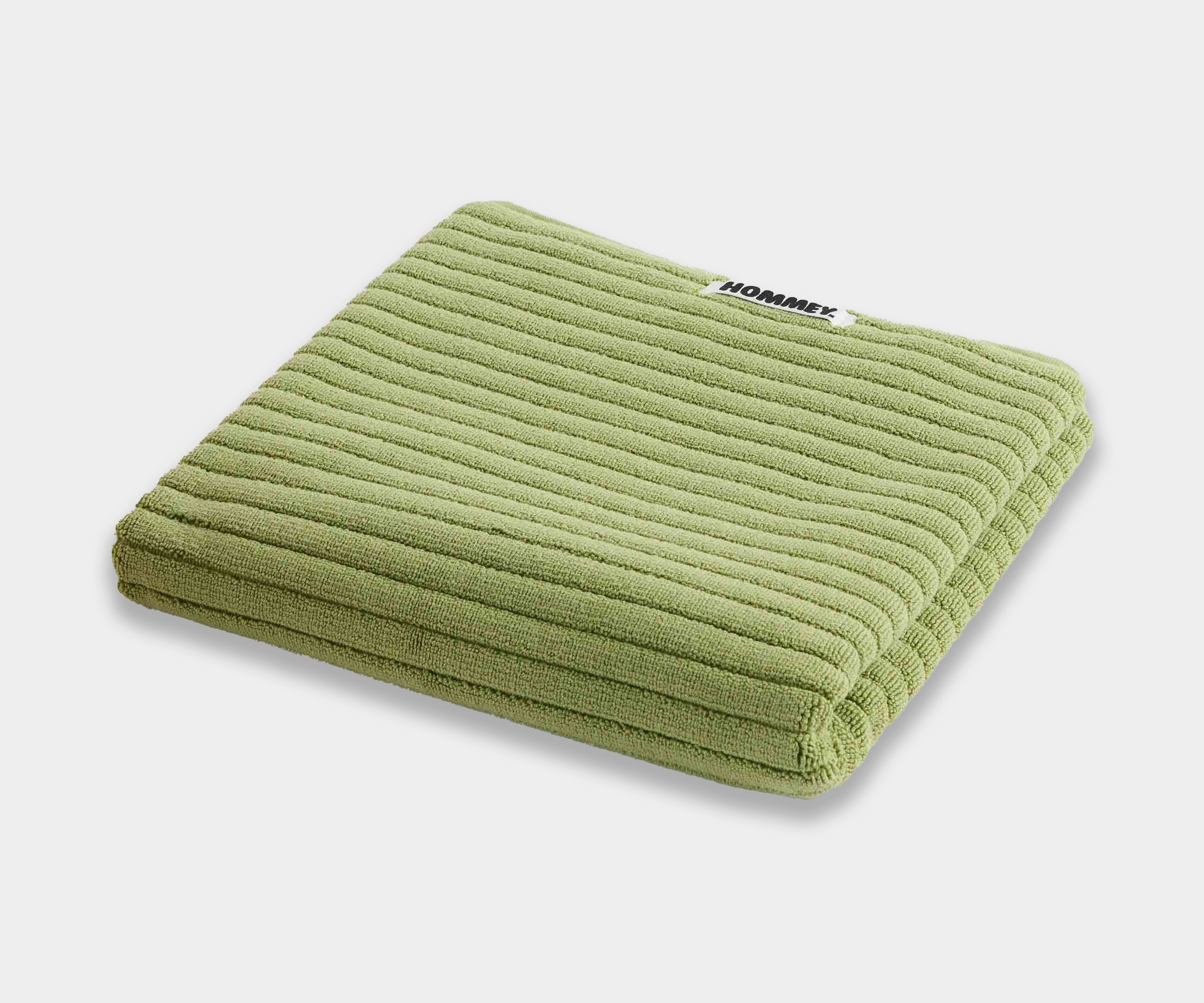 light green bath mat sitting on white background