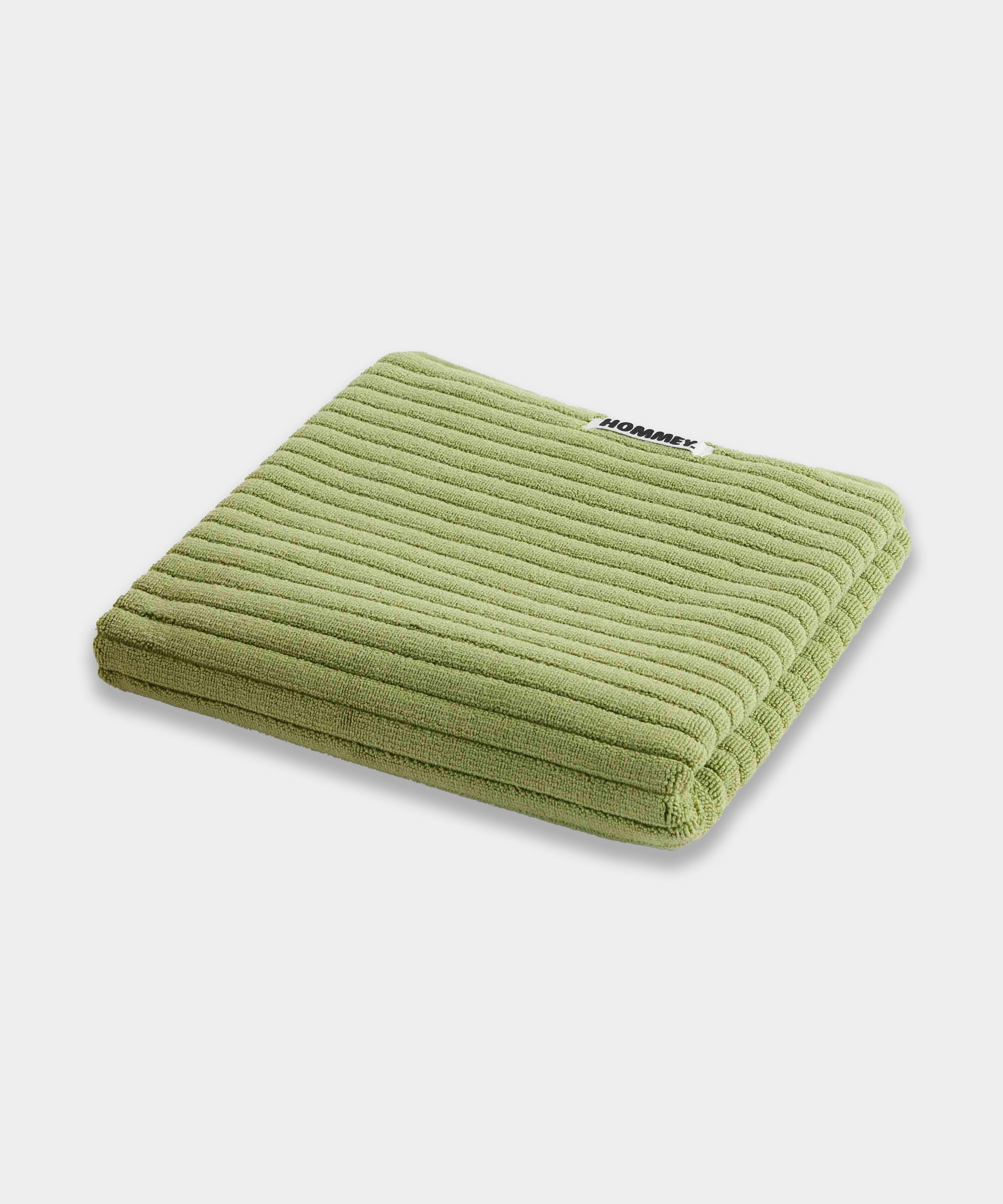 light green bath mat sitting on white background