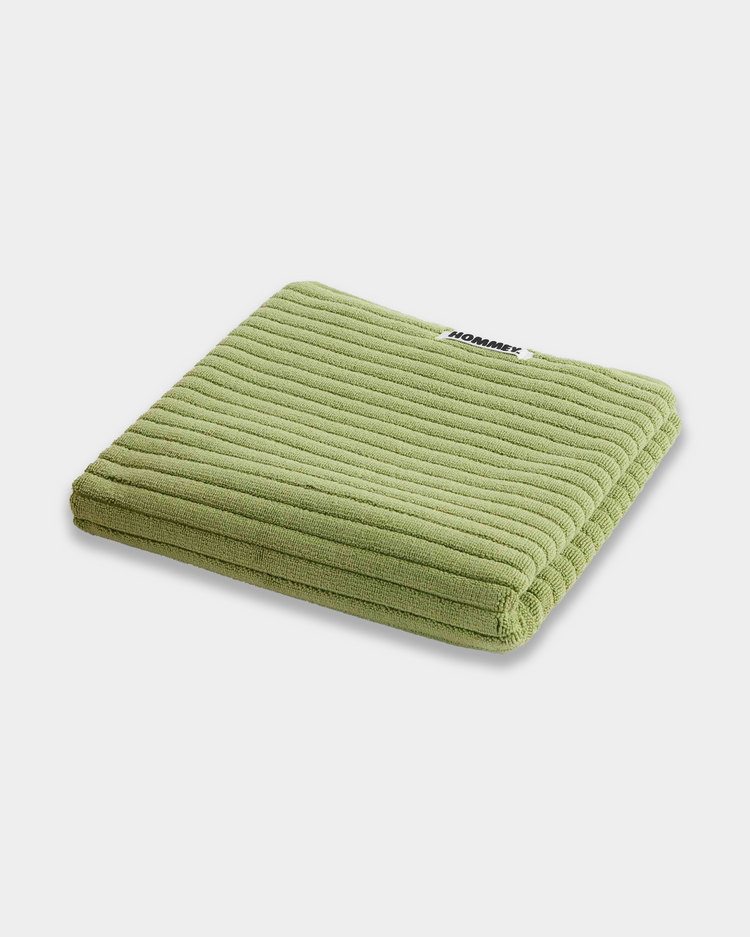 light green bath mat sitting on white background