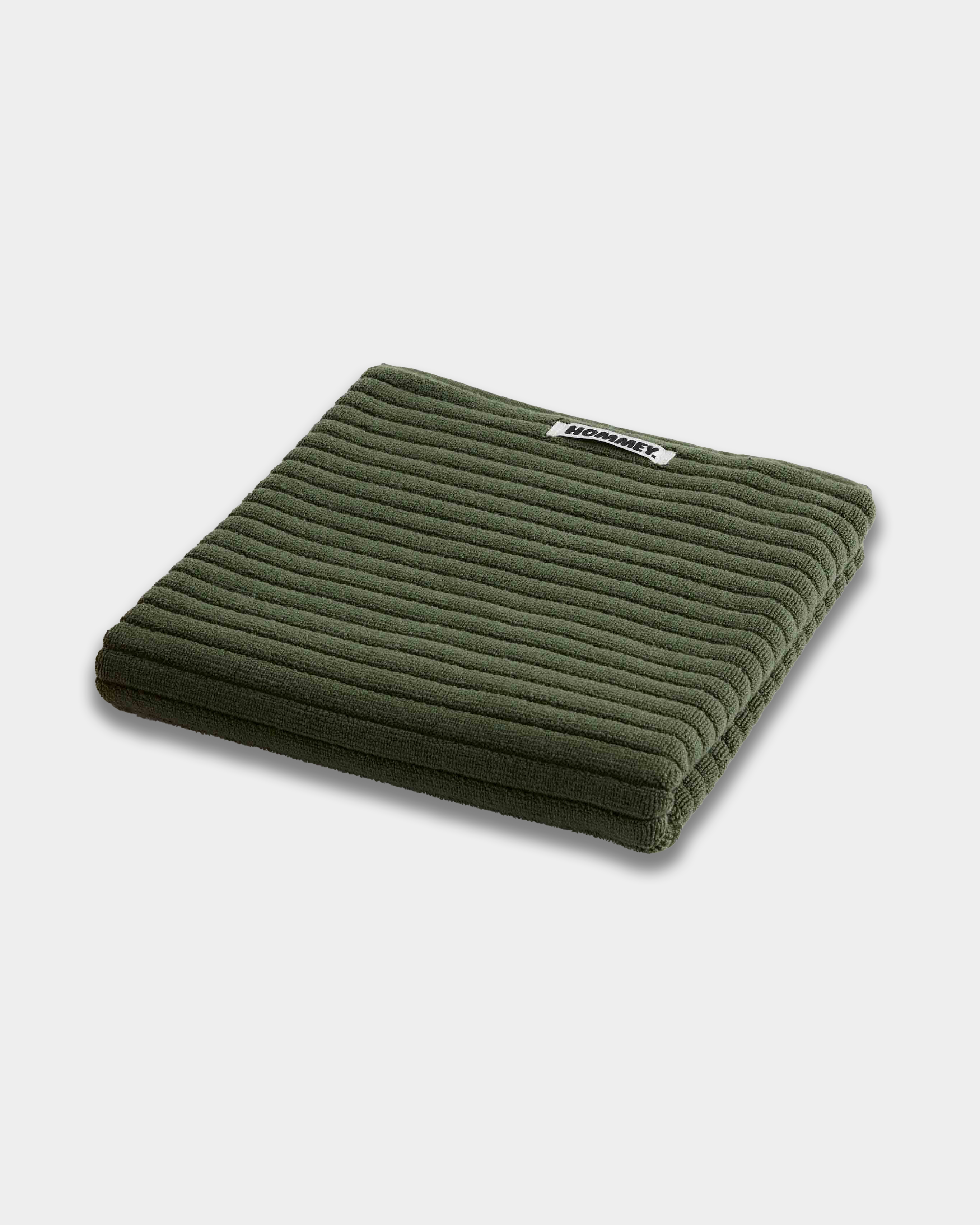 dark green bath mats sitting on white background