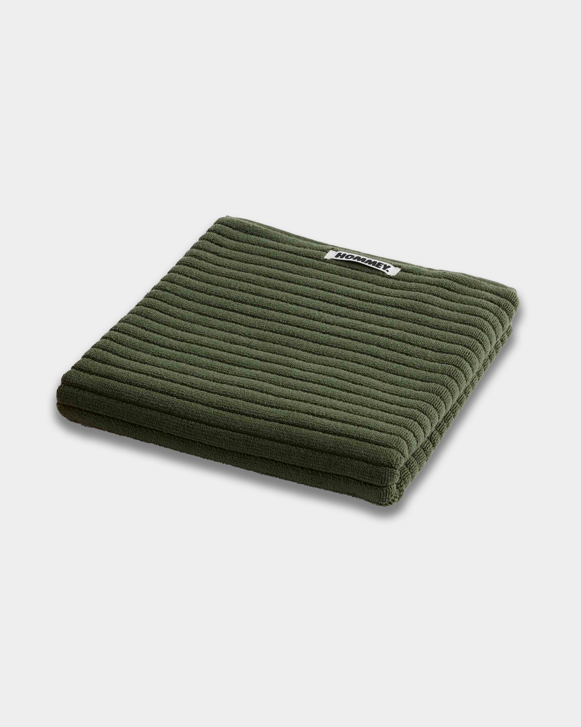 dark green bath mats sitting on white background