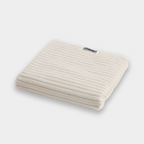 white bath mat sitting on white background