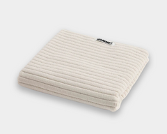 white bath mat sitting on white background