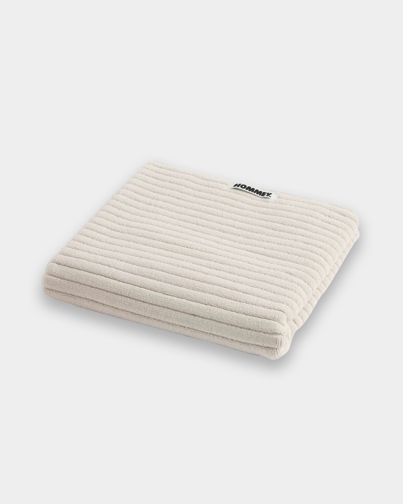 white bath mat sitting on white background