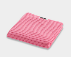 pink bath mat sitting on white background