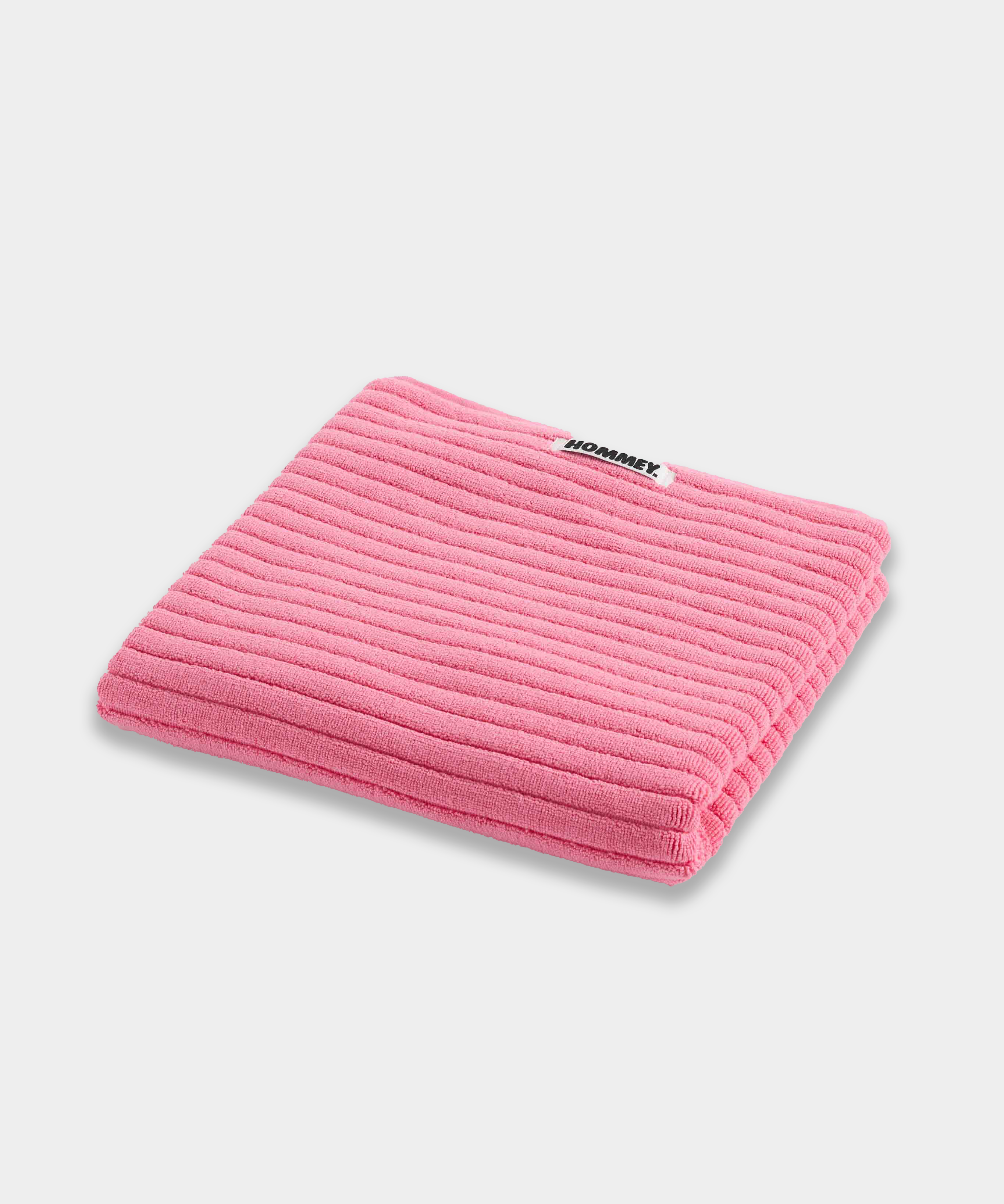 pink bath mat sitting on white background