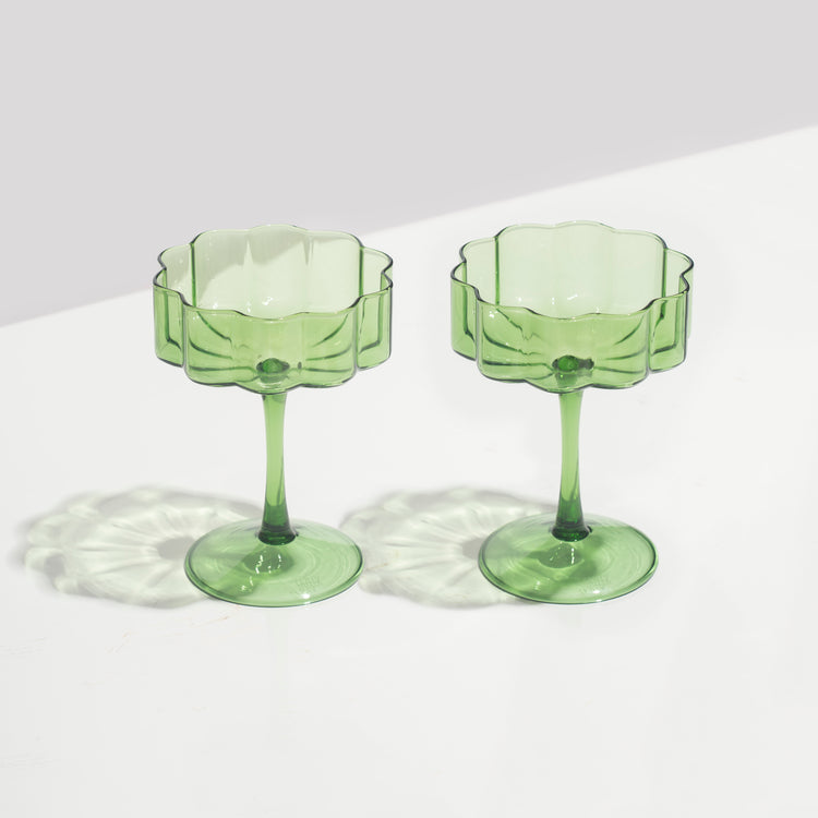 green wave coupe glasses sitting on white background