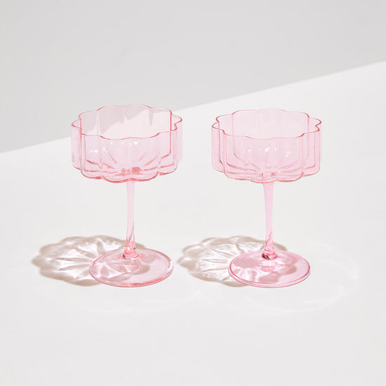 pink wave coupe glasses sitting on white background