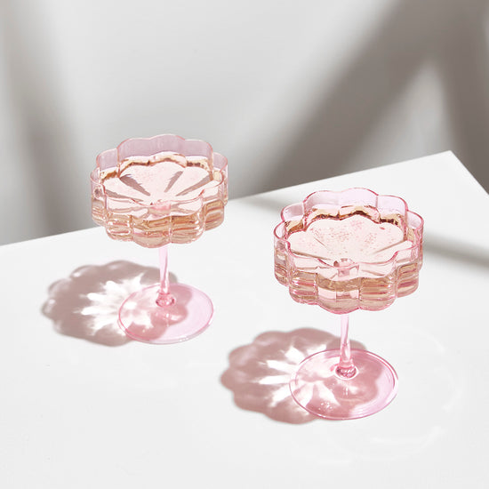 pink wave coupe glasses sitting on white background