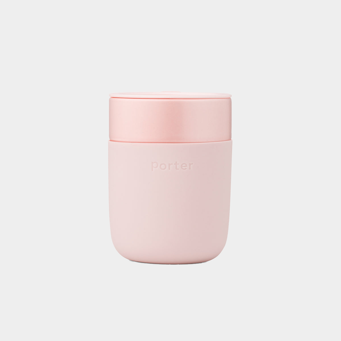 pink ceramic takeaway mug sitting on white background