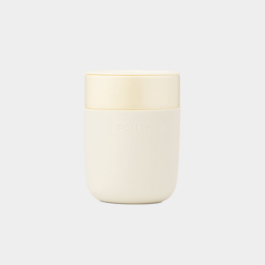 cream ceramic takeaway mug sitting on white background