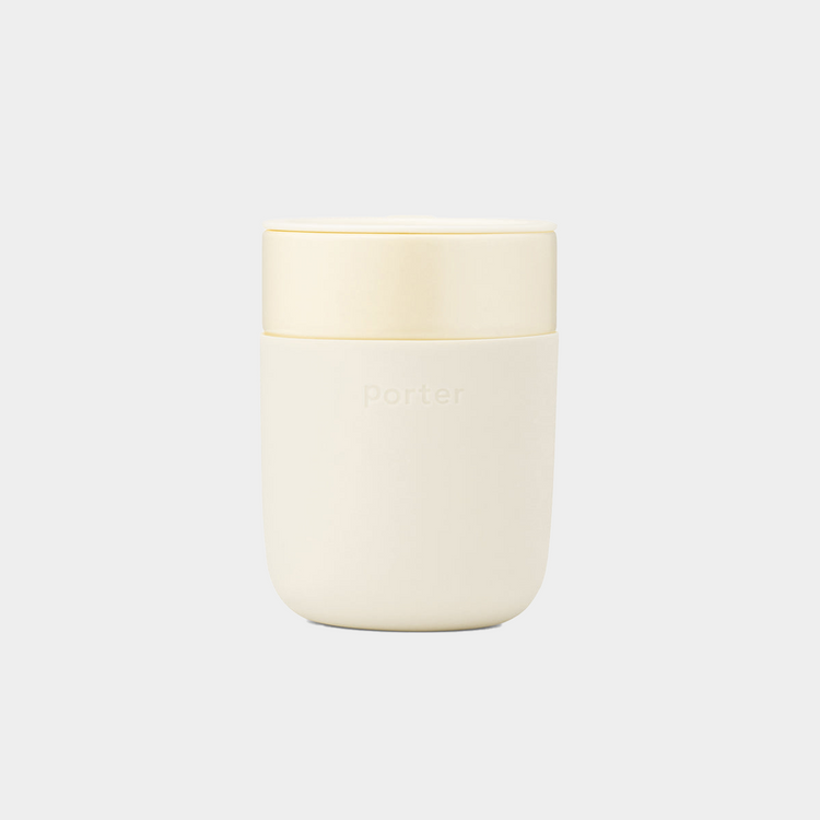 cream ceramic takeaway mug sitting on white background