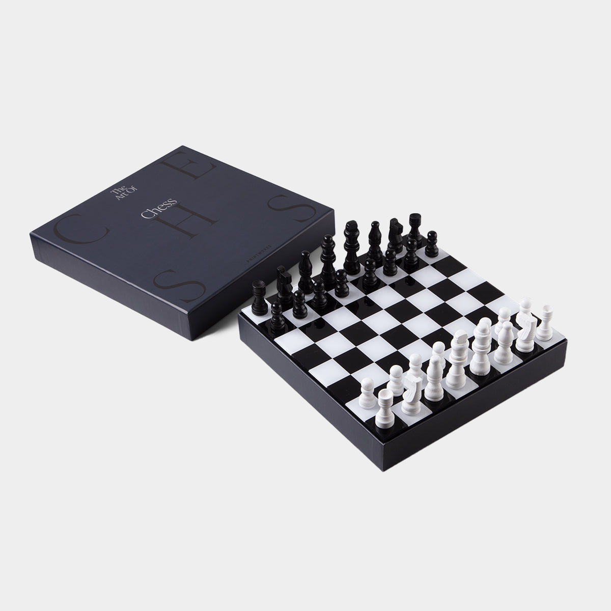 opened up box of black chess set on white background