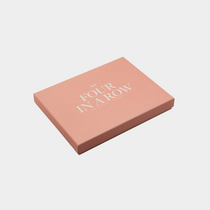 Classic Games Four in a Row board game in soft pink packaging with elegant typography