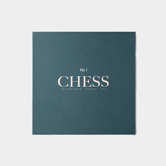 blue green chess set packaging on white background