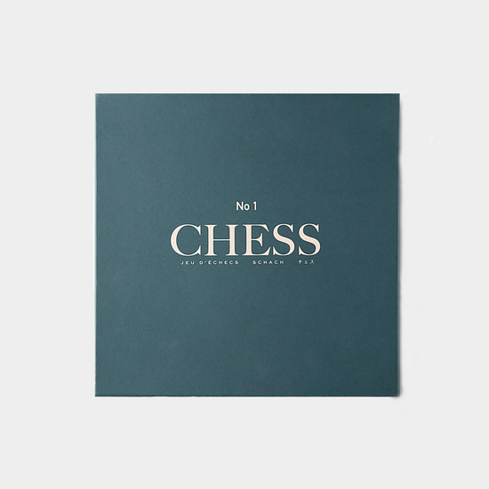 blue green chess set packaging on white background