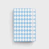 notebook with blue diamond pattern sitting on white background