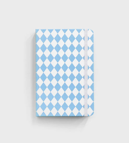 notebook with blue diamond pattern sitting on white background