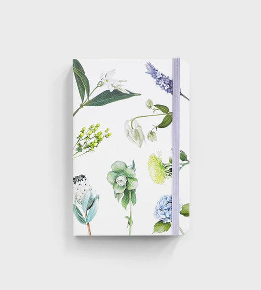 notebook with flowers on it sitting on white background