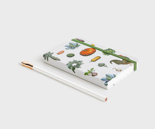 notebook with vegetable pattern lying down on white background