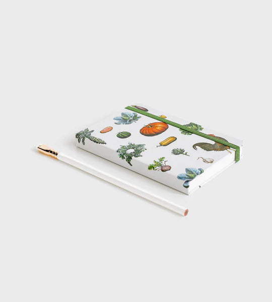 notebook with vegetable pattern lying down on white background