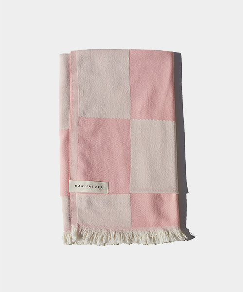 soft pink and white beach towel folded 