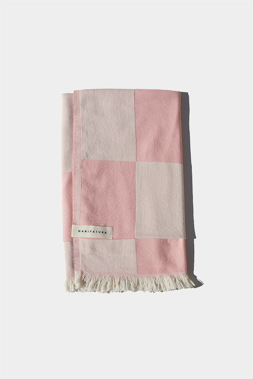 soft pink and white beach towel folded 