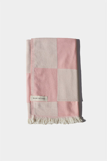 soft pink and white beach towel folded 