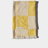 citrus yellow and white beach towel folded