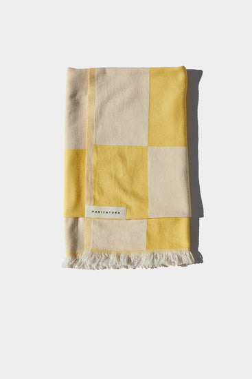 citrus yellow and white beach towel folded