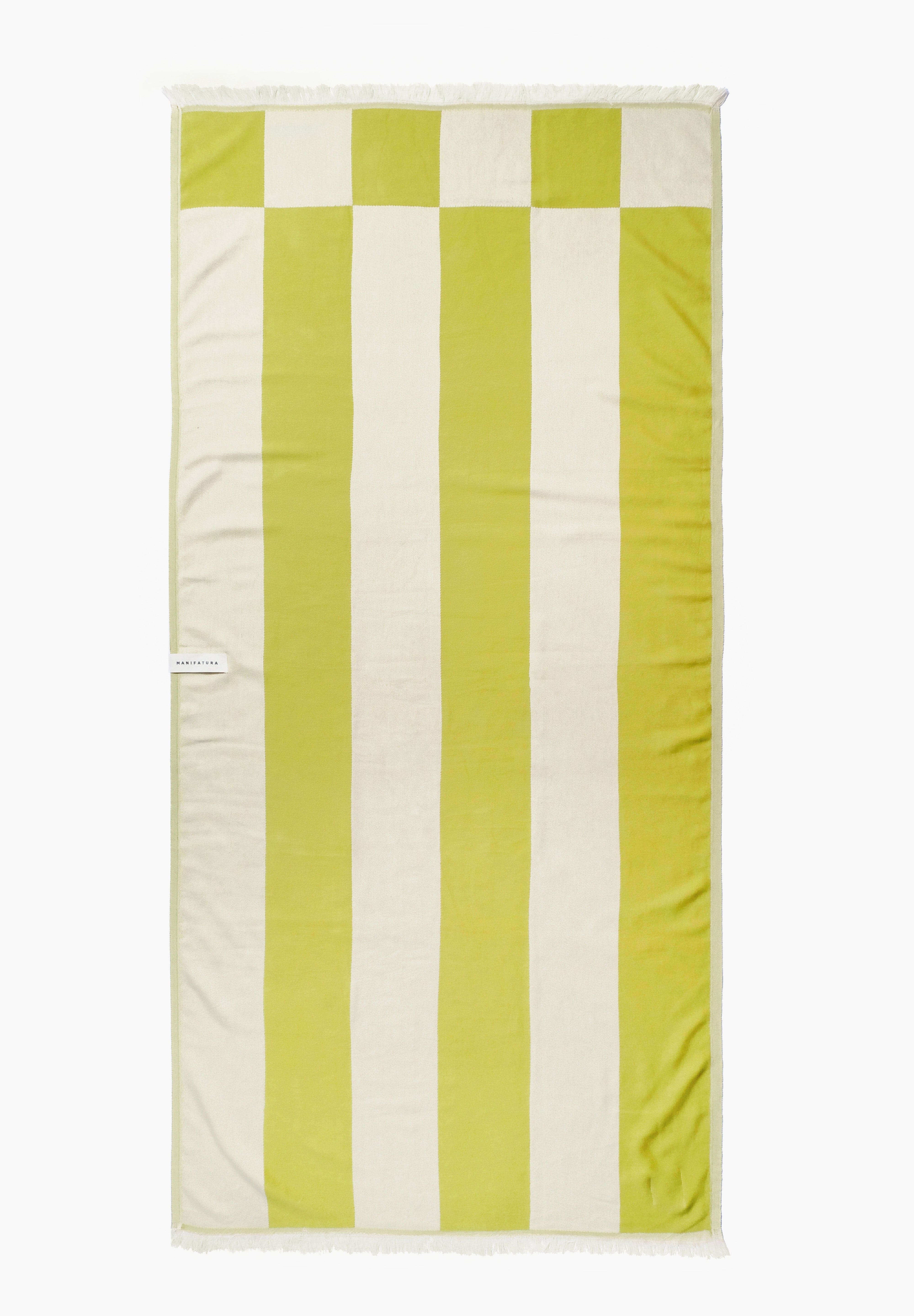 pistachio green and white beach towel laid out flat 