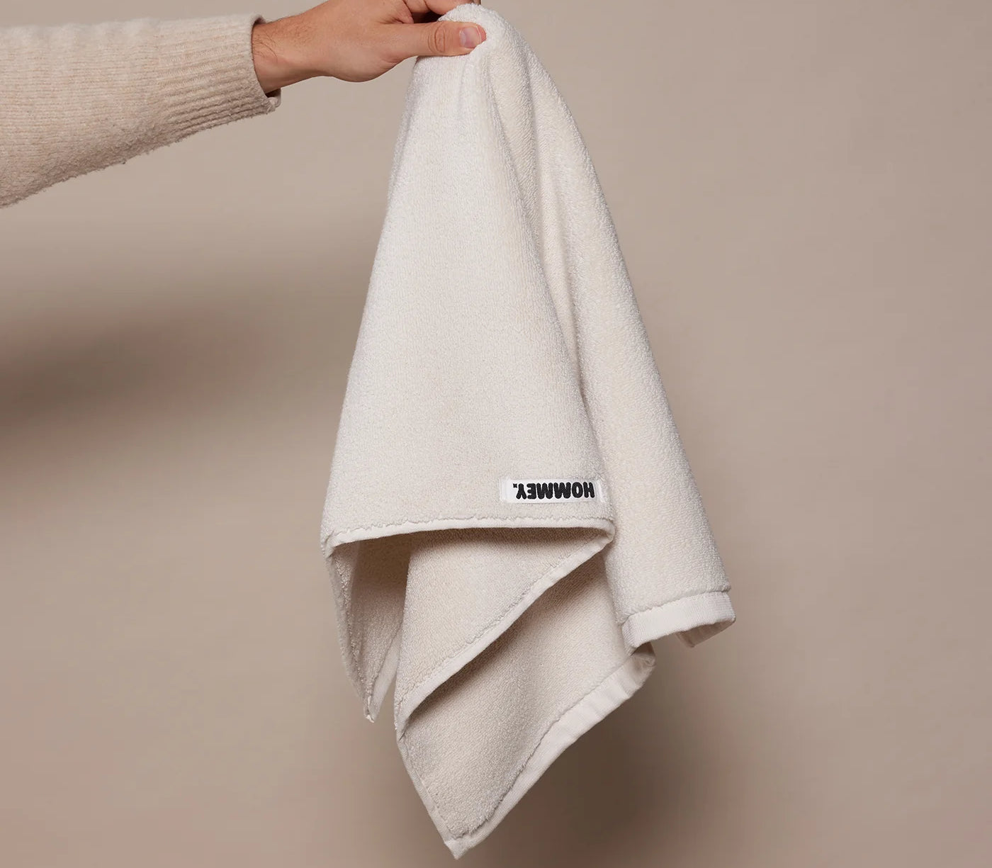 white towel being held up by woman