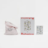 opened up set of a puzzle with flowers on it sitting on white background