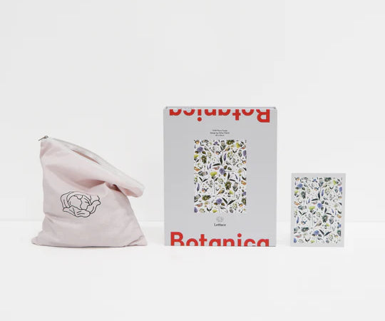opened up set of a puzzle with flowers on it sitting on white background