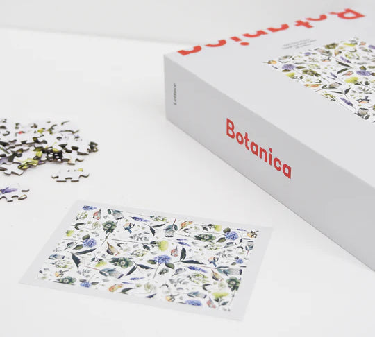 puzzle set of flowers lying down on white background with puzzle completed 
