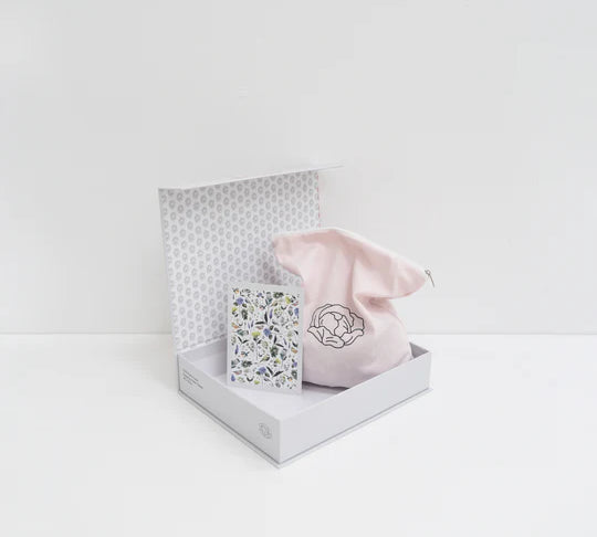 opened up set of a puzzle with flowers on it sitting on white background