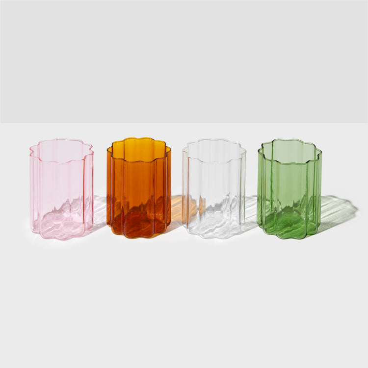 different coloured wave glasses sitting on white table