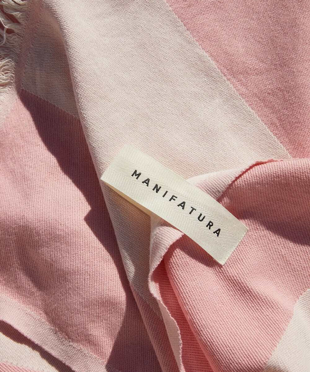 up close picture of a pink and white beach towel