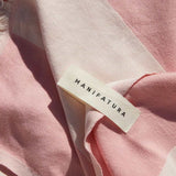 up close picture of a pink and white beach towel