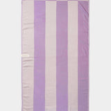 purple beach towel laid out flat