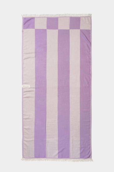 purple beach towel laid out flat