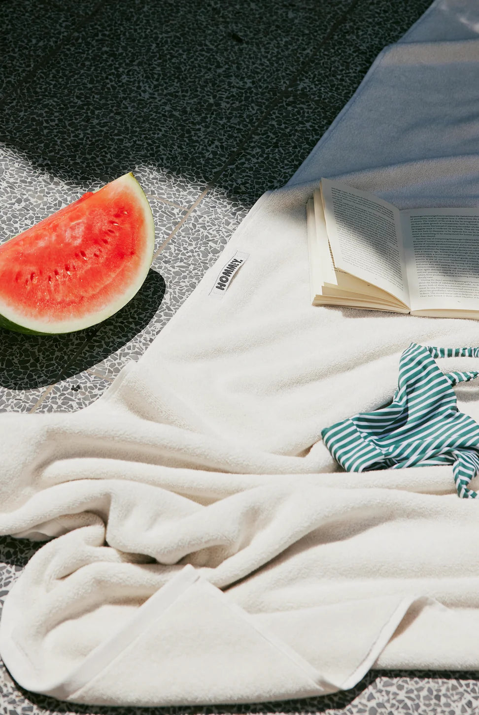 white towel sitting on a pool side