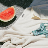 white towel sitting on a pool side