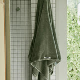 dark green towel hanging up