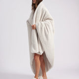 girl wrapped up with a white throw blanket