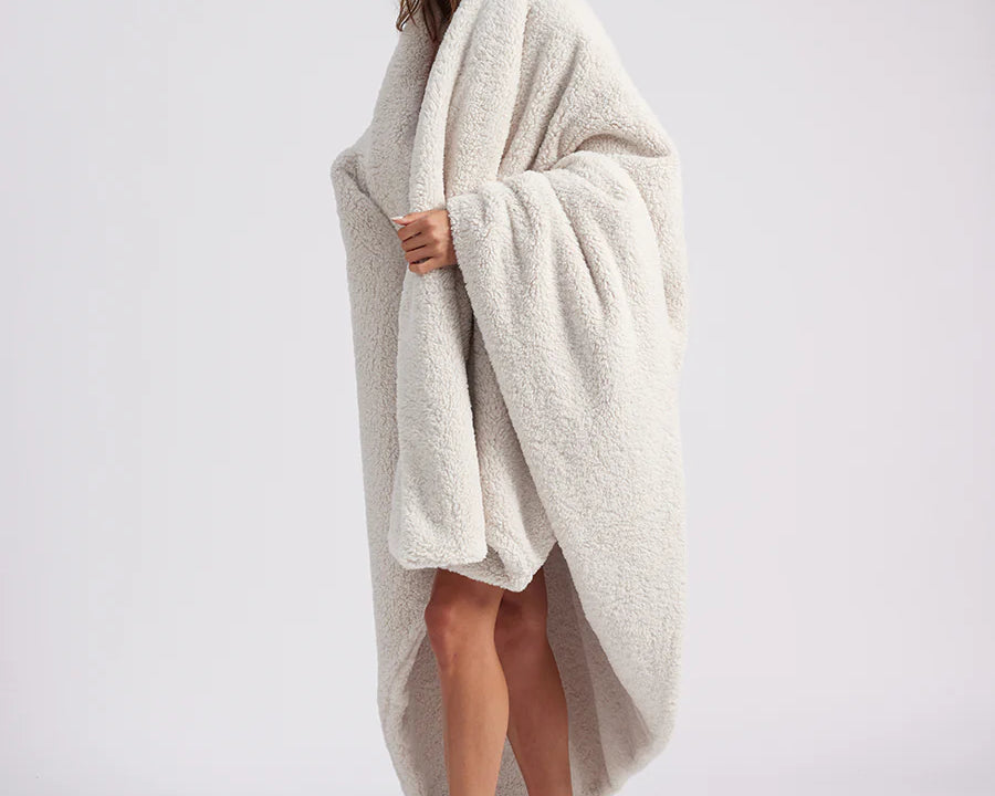 girl wrapped up with a white throw blanket